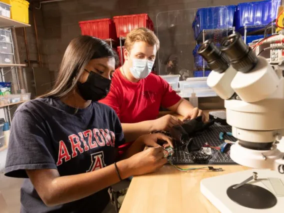 Colin and Nisha using lab equipment