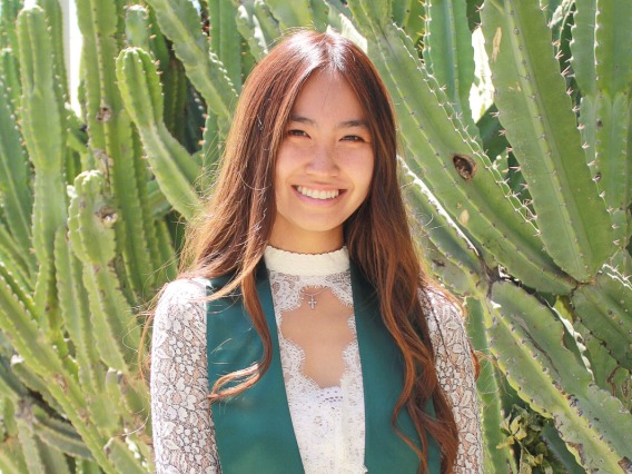 woman graduation photo green cactus background