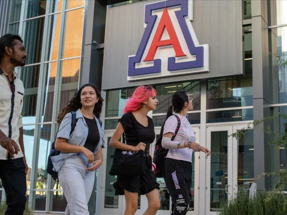 students walking in front of north rec center with block A in the background