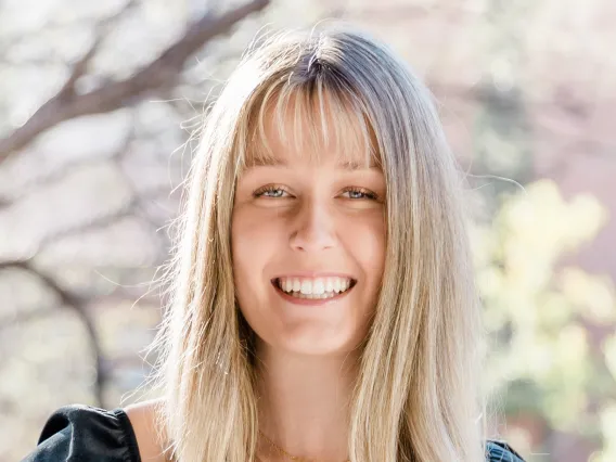 student headshot with tree background