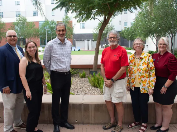 Dr. John Lee Copton poses with faculty and staff during the signing of his gift agreement