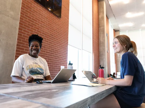 Two students working in the Honors Village Foyer