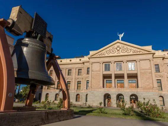 photo of government building with bell out front