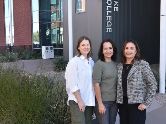 image of three women standing in front of the Honors Village