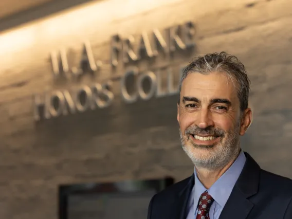 headshot of john pollard in front of w.a. franke sign