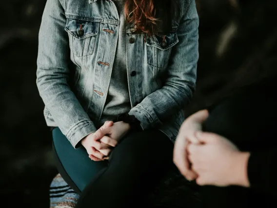 woman wearing grey jacket sitting