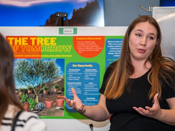 Student giving a poster presentation