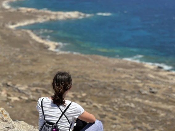 person sitting by ocean 