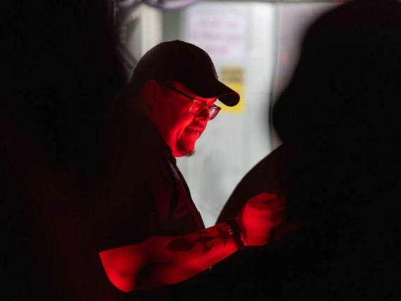 person illuminated by red light and shadows