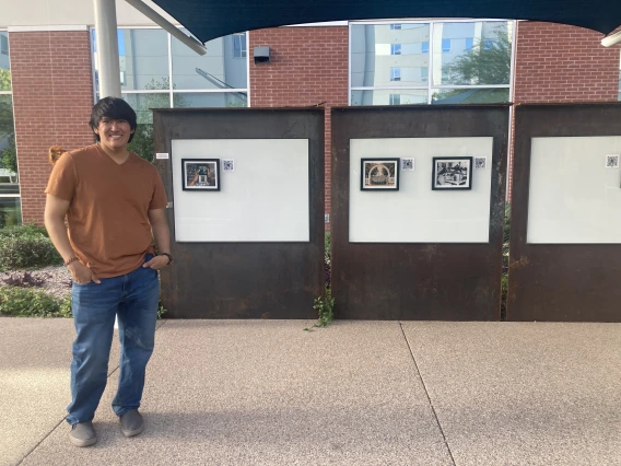 person in front of displayed photographs