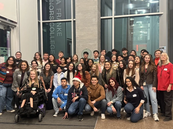 group of students in front of window