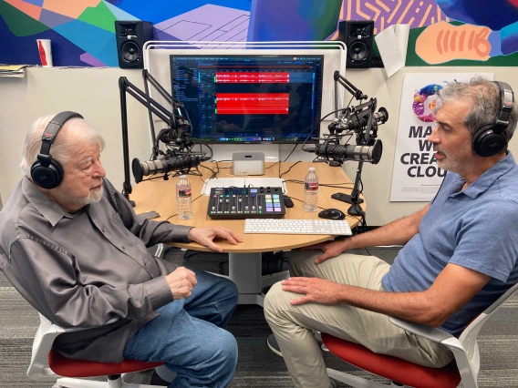 two guests sitting in front of podcast equipment