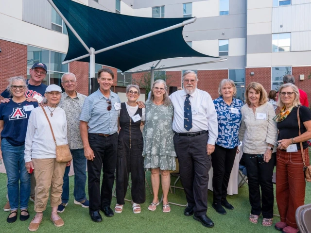 group of people standing in courtyard together