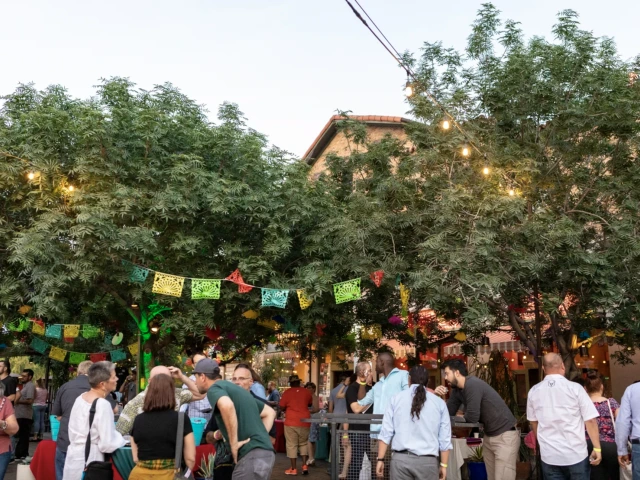 group of people gathered under lights celebrating agave heritage festival