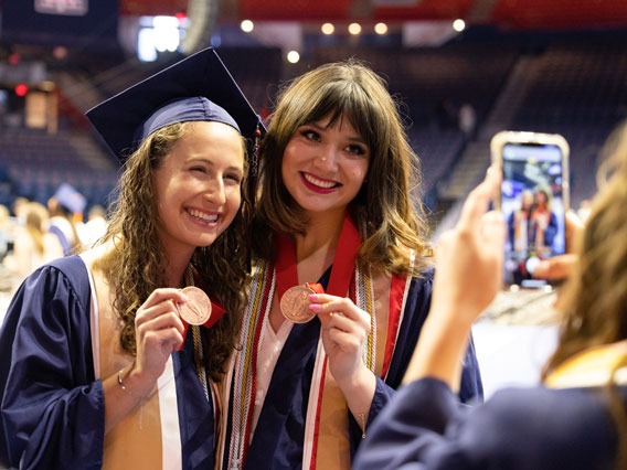 Spring 2022 grads show off their graduation medallions 