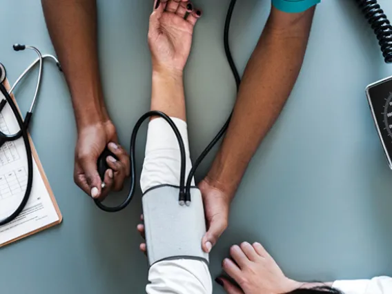 Nurse taking the blood pressure of patient