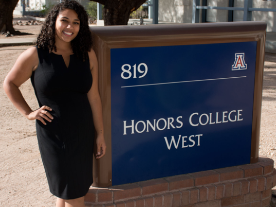 Leah Crowder in front of Honors College Sign
