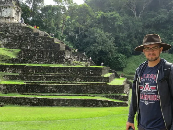 Photo of Anthony Polanco beside Mayan temple Palenque