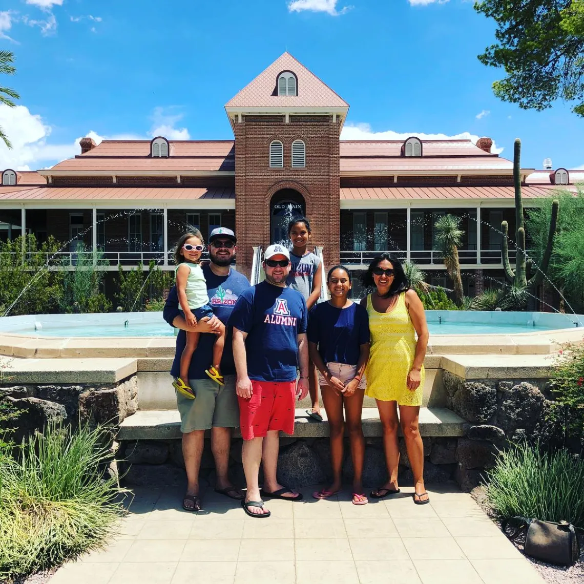 Alumni Tyler Quillin and family in front of Old Main