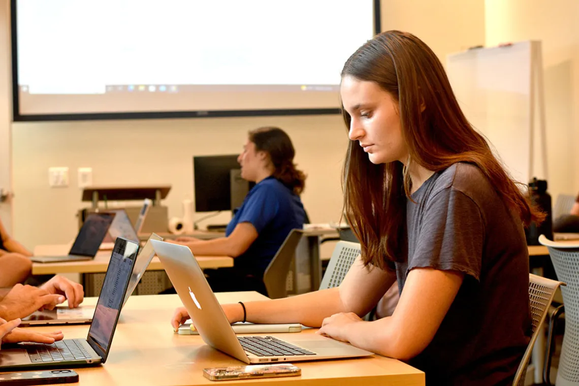 female capstone student working in class