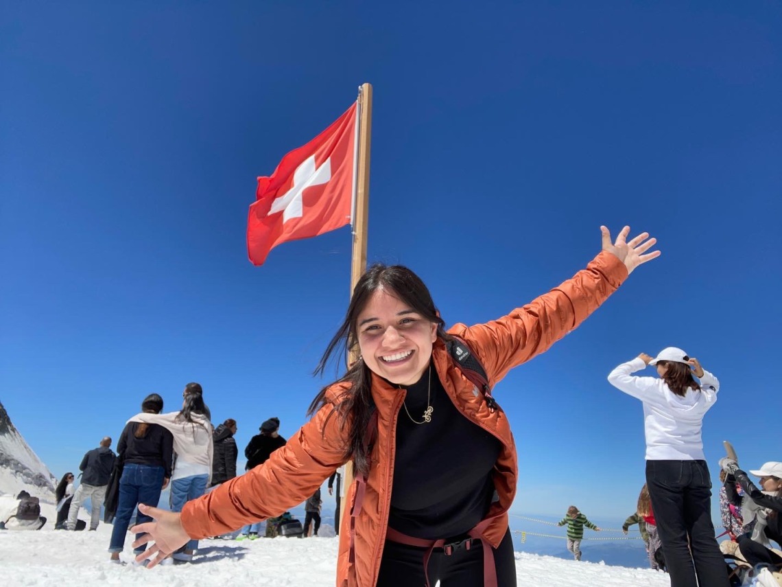 Jennifer Gaxiola pictured in front of swiss flag blue sky background