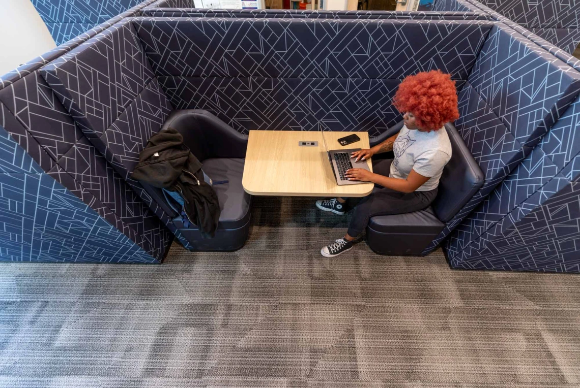 person sitting at table working on computer