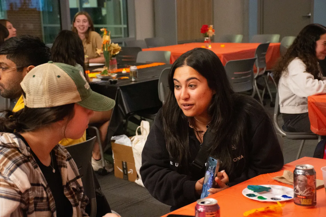 Two students talking at an event.