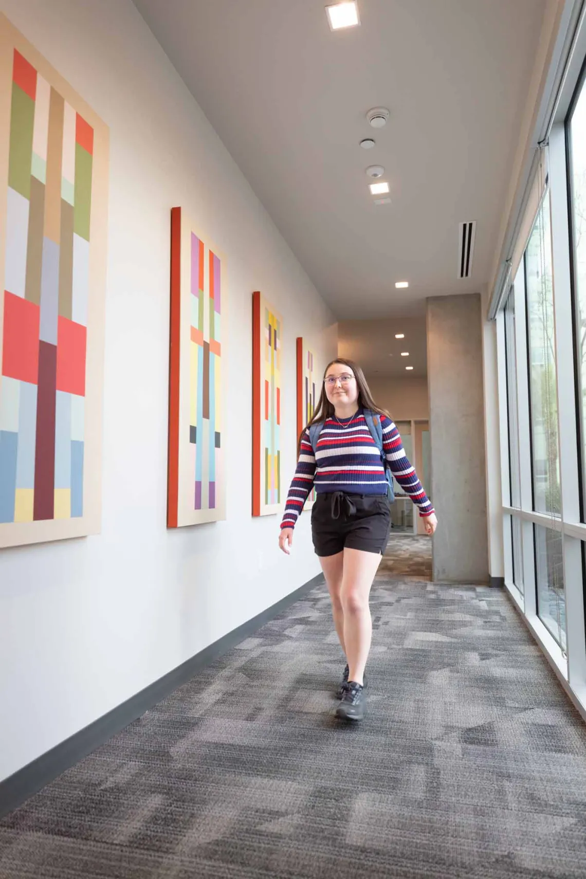 Student walking down hall in Honors offices