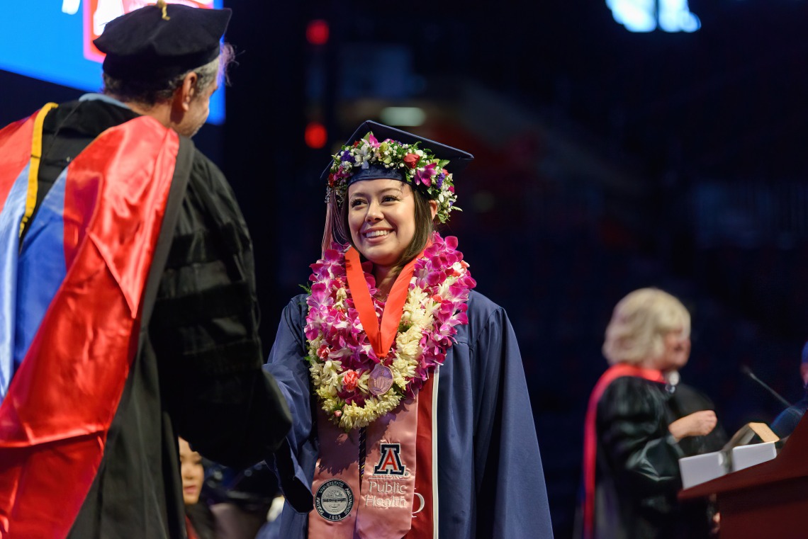 A Franke Honors graduate crosses the stage at McKale Center