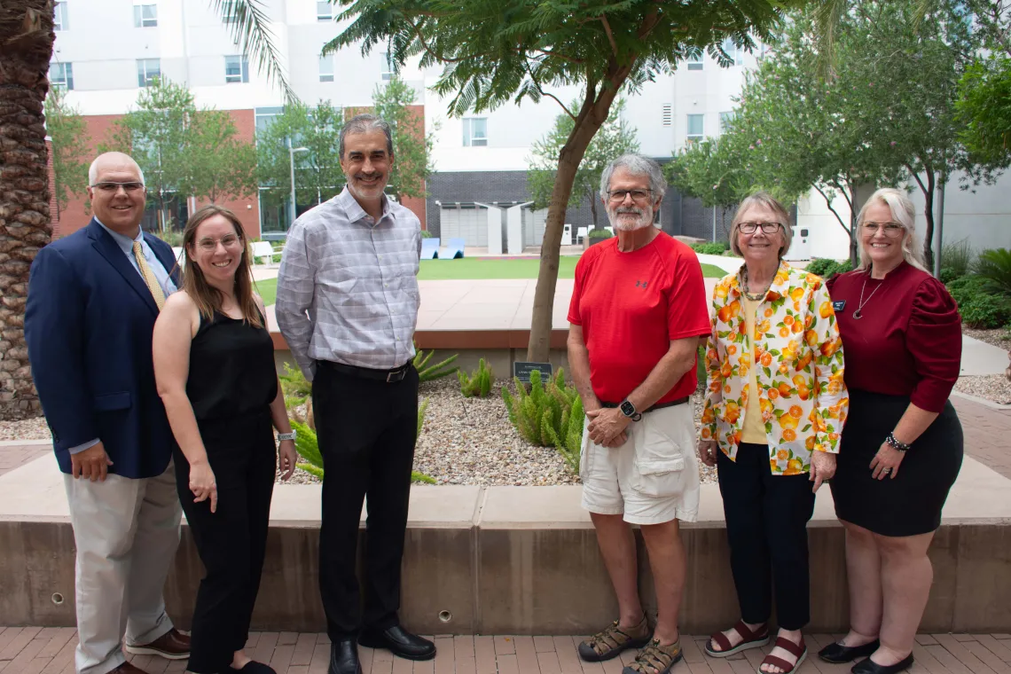 Dr. John Lee Copton poses with faculty and staff during the signing of his gift agreement