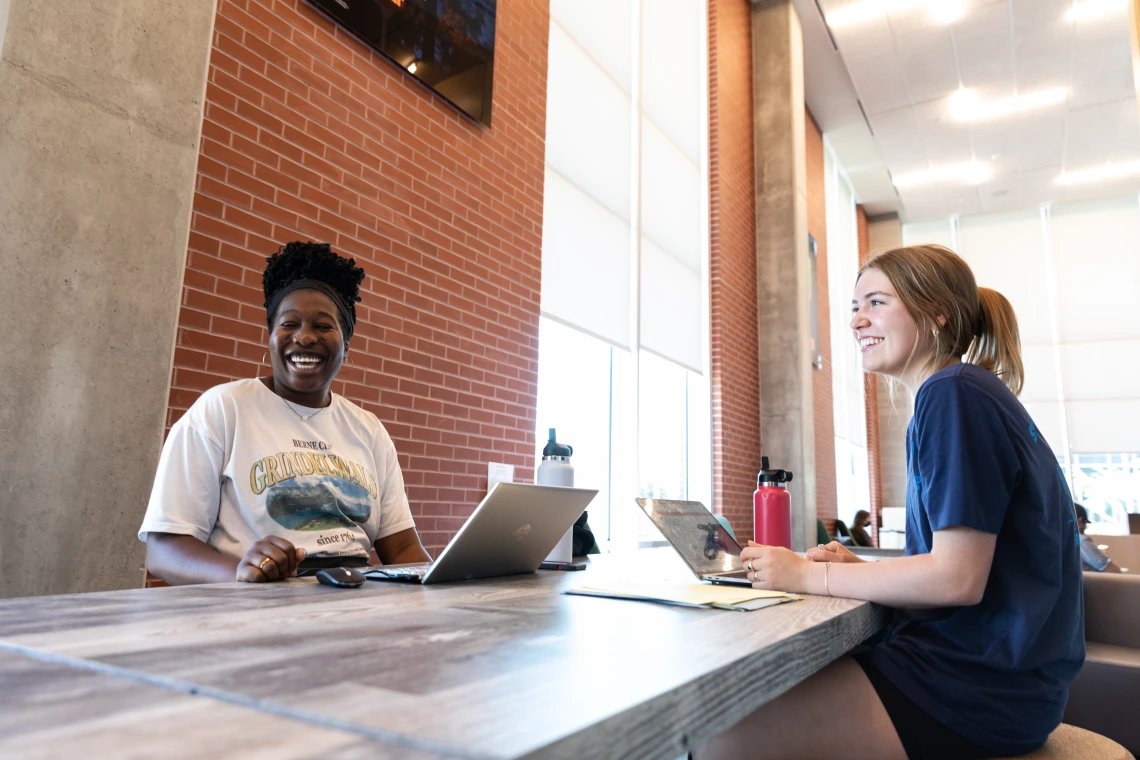 Two students working in the Honors Village Foyer