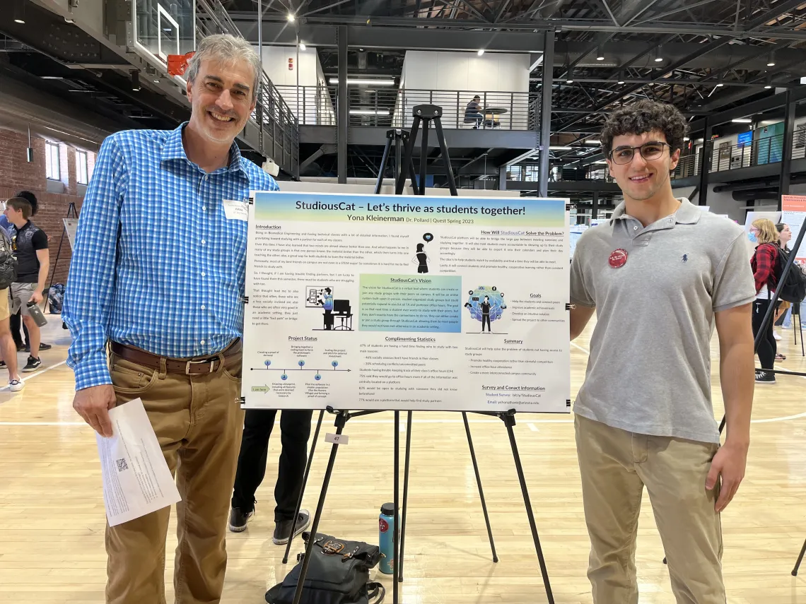 John Pollard and Yona Klienerman standing with a poster presentation