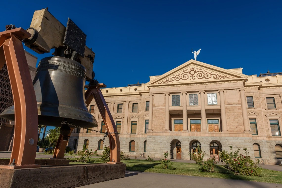 photo of government building with bell out front