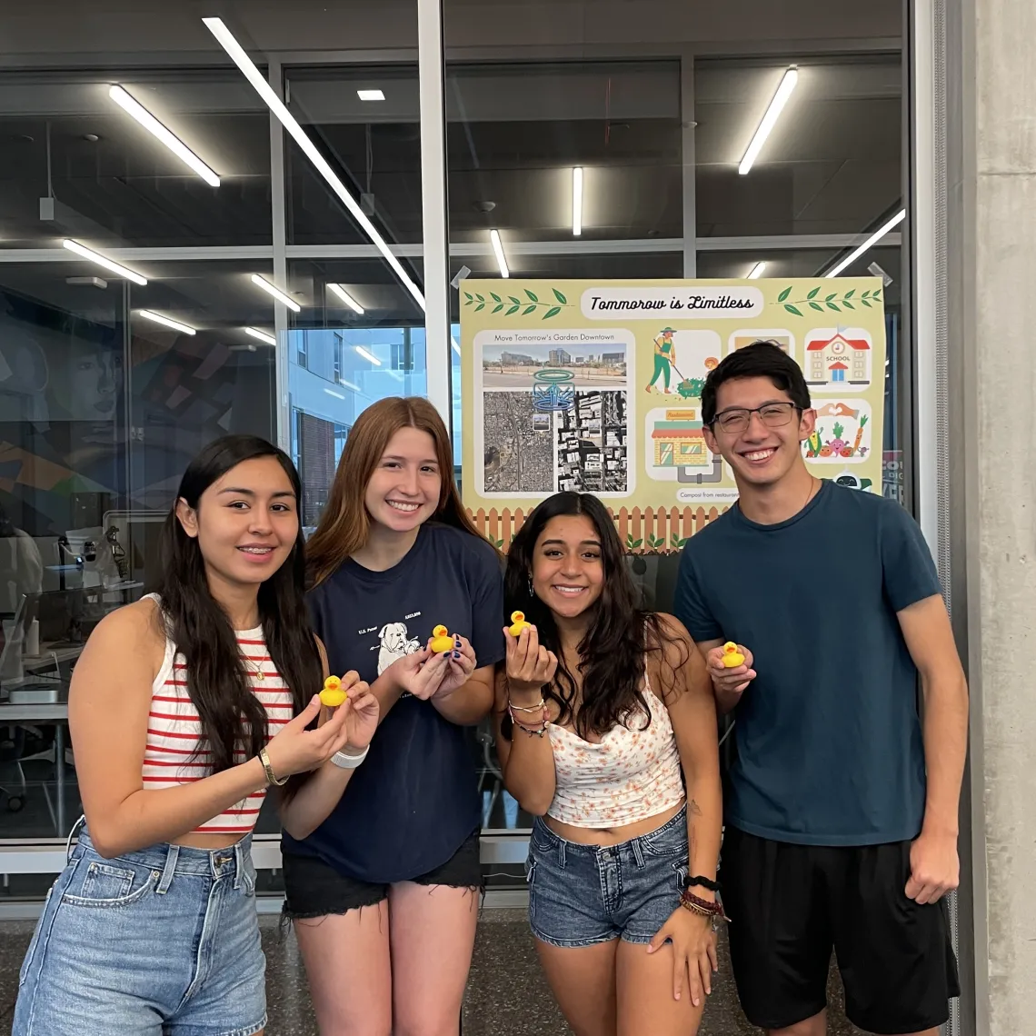 Students posing in front of their poster presentation in Honors Village 1067/68