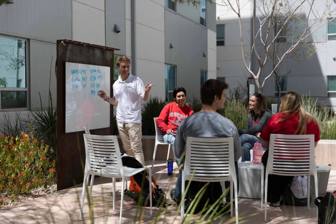 Students writing on the white board