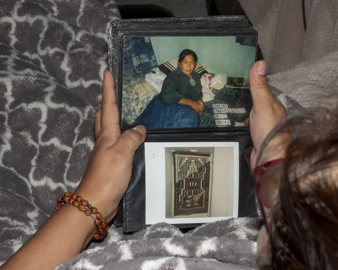 someone flipping through a photo book, image of woman pictured