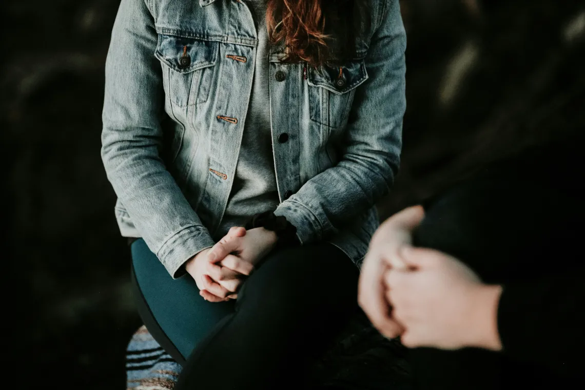 woman wearing grey jacket sitting