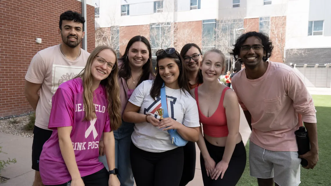 students standing in group smiling at camera