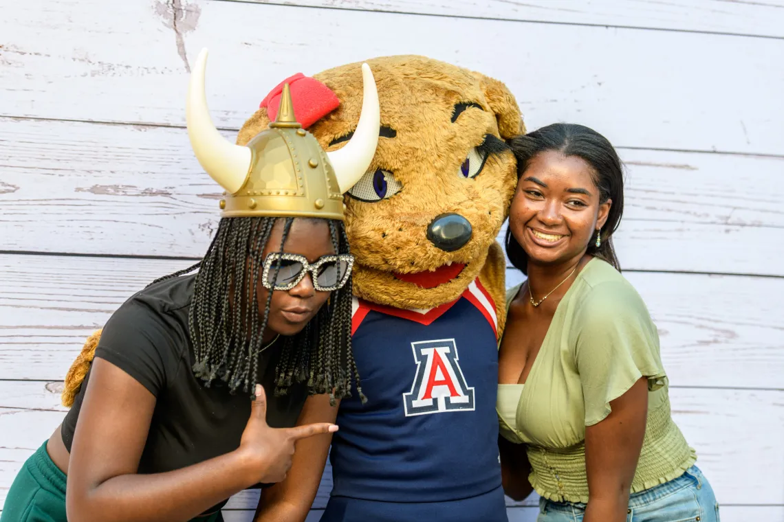 Two students with Wilma Wildcat