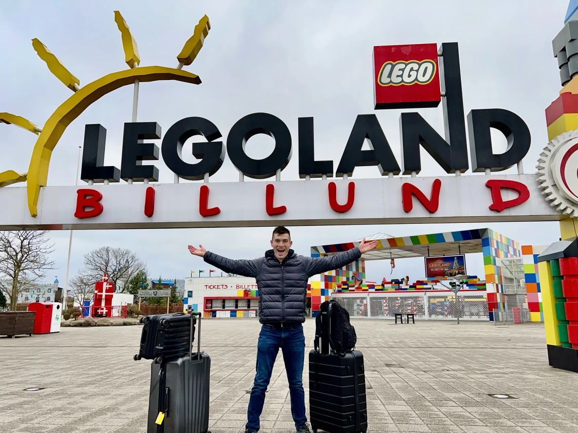 person standing in front of legoland sign