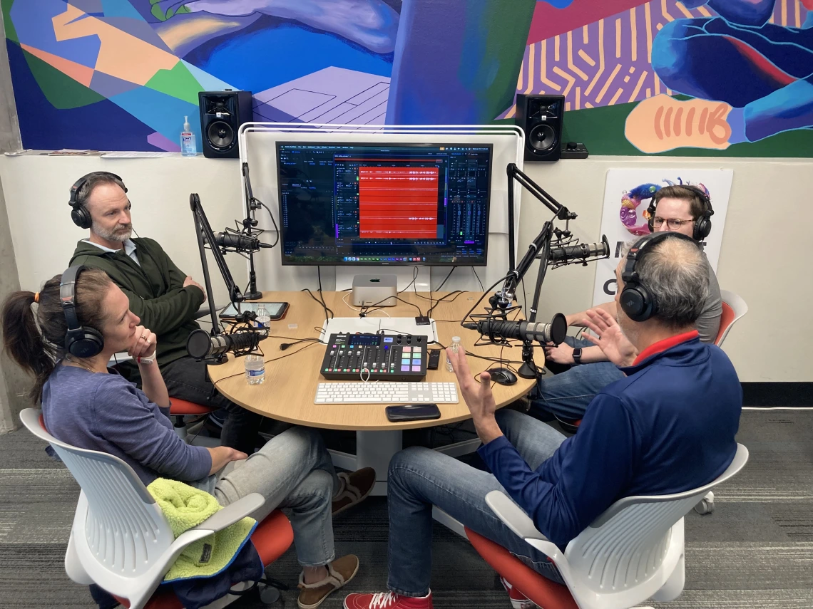 people sitting in front of podcast equipment