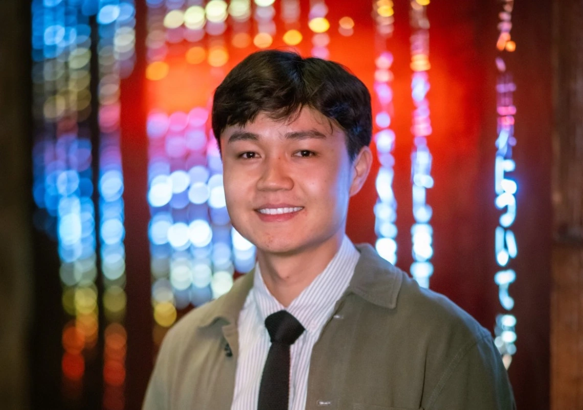 headshot of person with red blue background