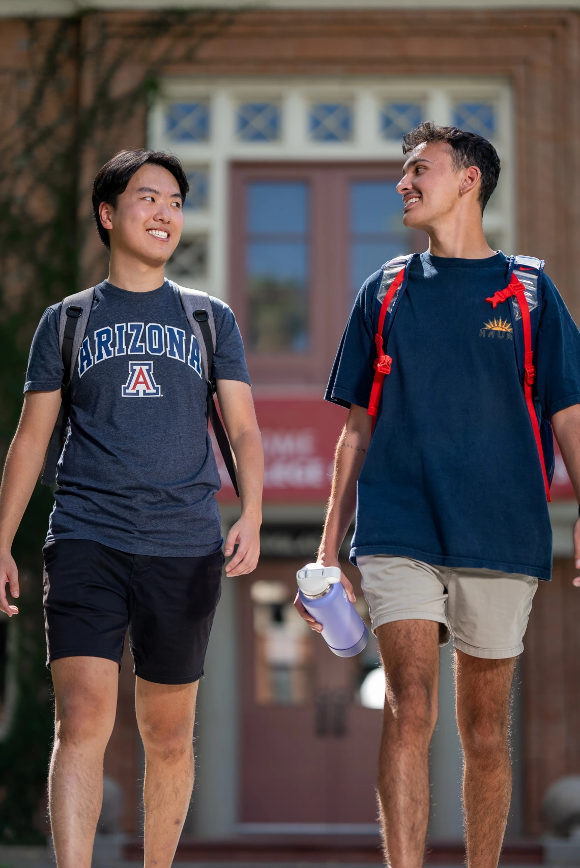 Two students walking together on campus