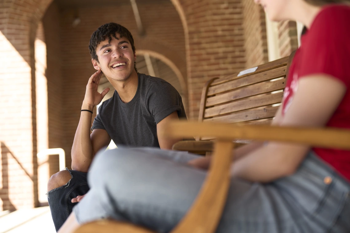 Students talking on verandah of Old Main