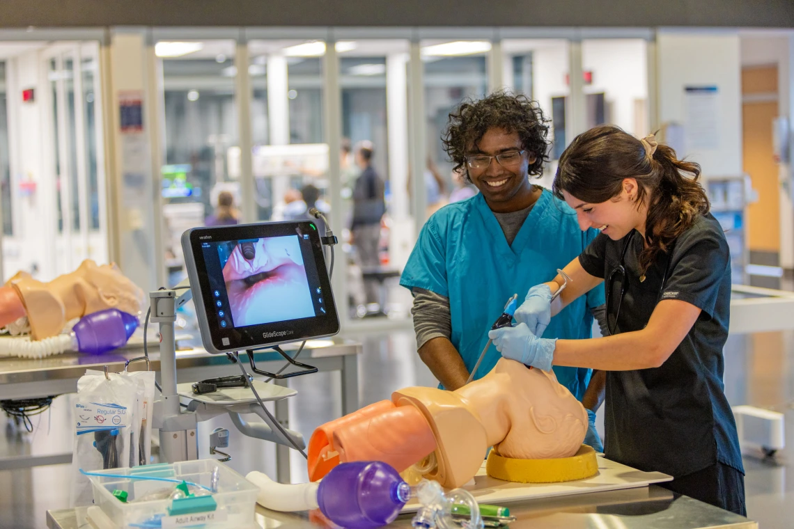 Students practicing with medical dummy in HSIB