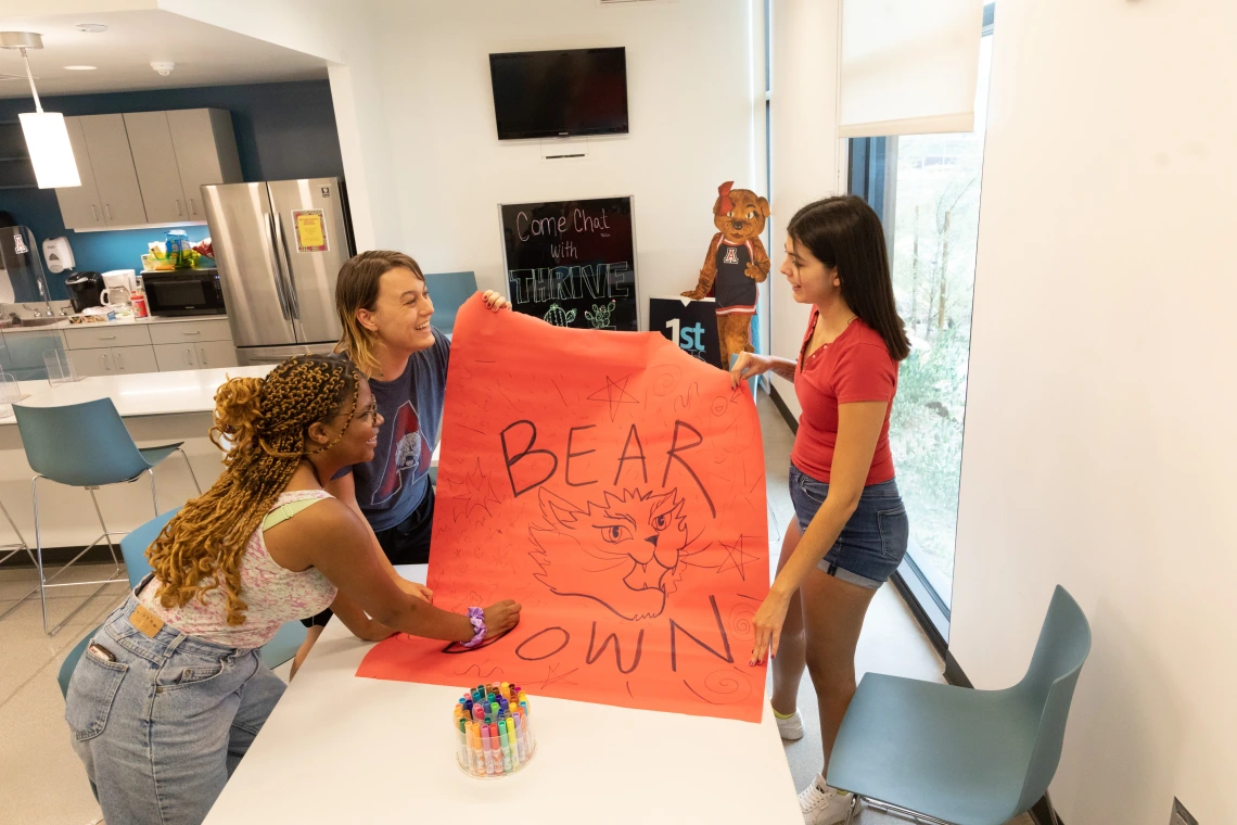 Two students making bear down sign