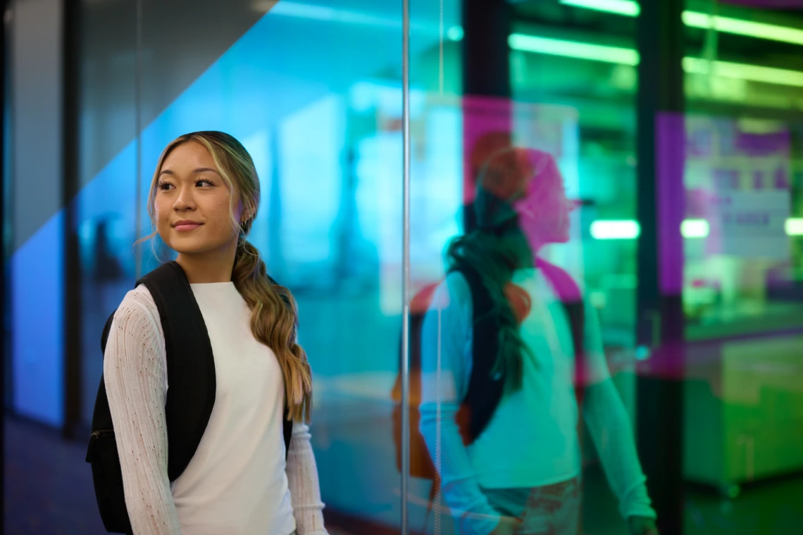 Student walking by mirror wall