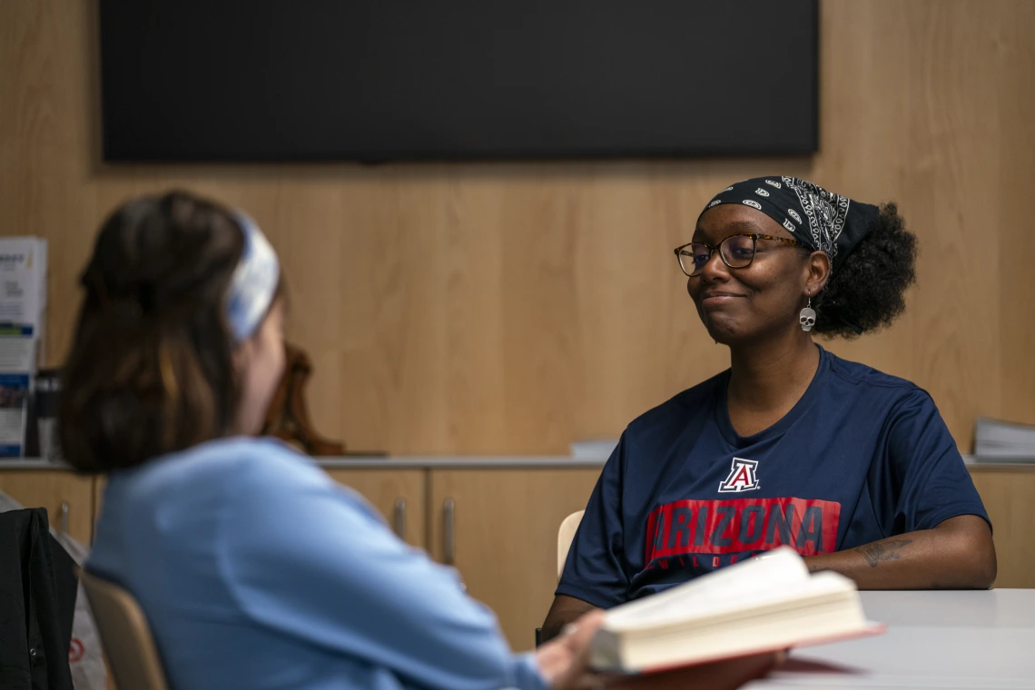 Two students talking in a room
