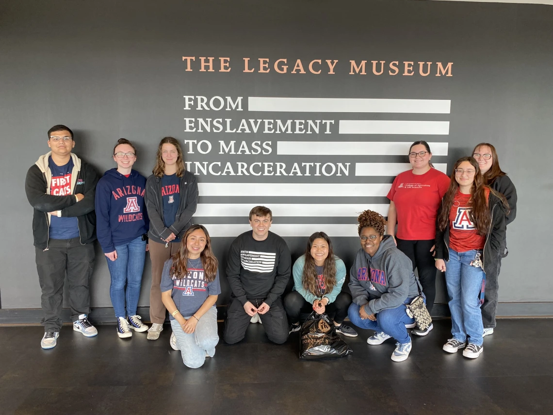 Students in front of a sign at the legacy museum