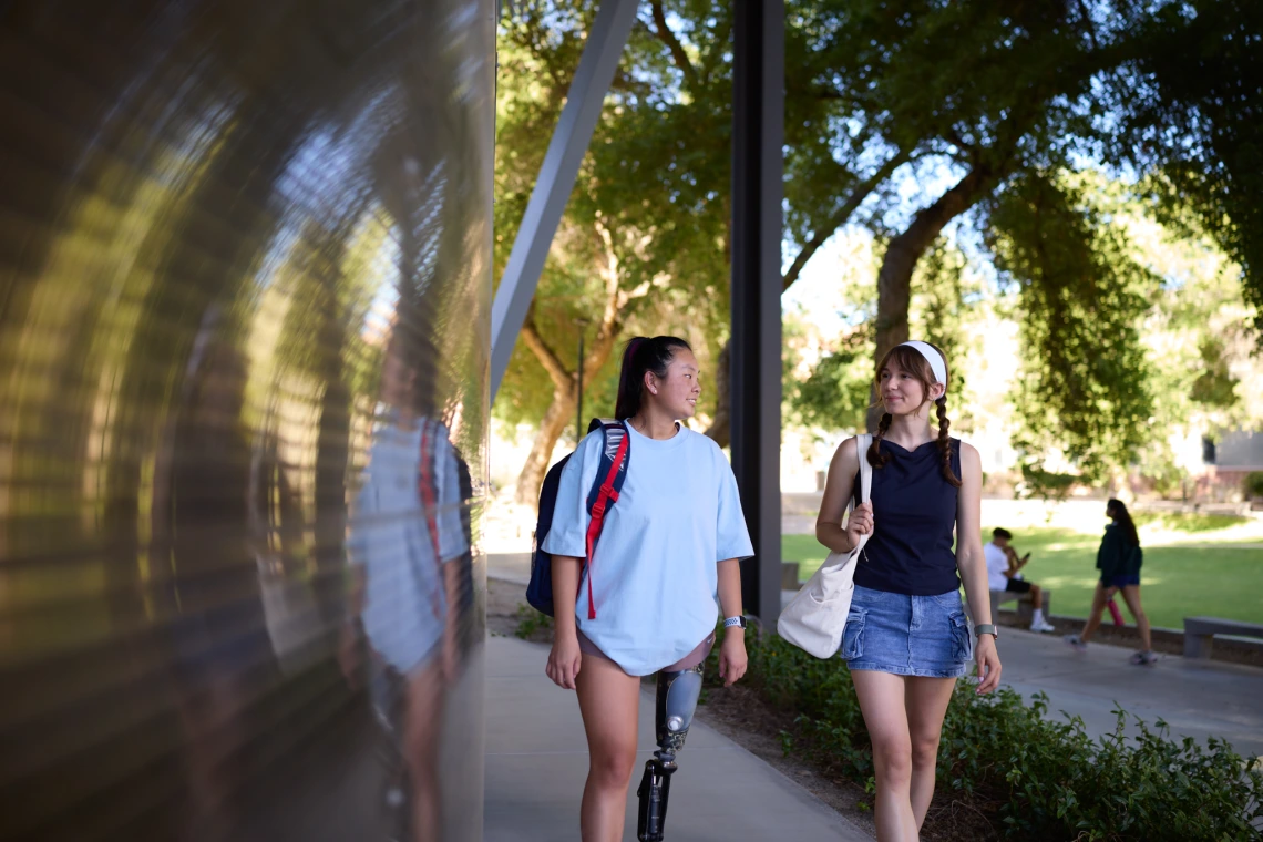 Two students walking on campus